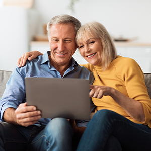 A couple seated together browsing online together.